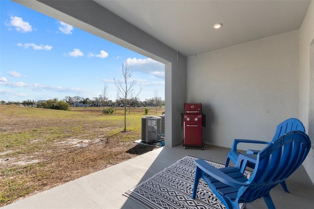 view of patio / terrace featuring a rural view and central air condition unit