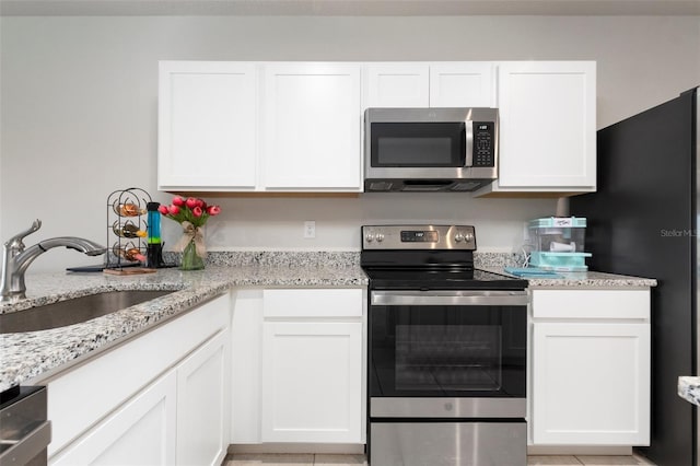 kitchen with white cabinets, sink, and appliances with stainless steel finishes