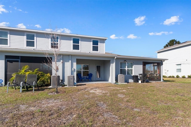 back of house featuring a sunroom and a yard