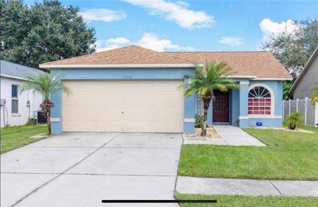 single story home featuring a front lawn, central AC unit, and a garage