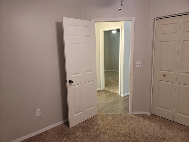 interior space with a closet and light colored carpet