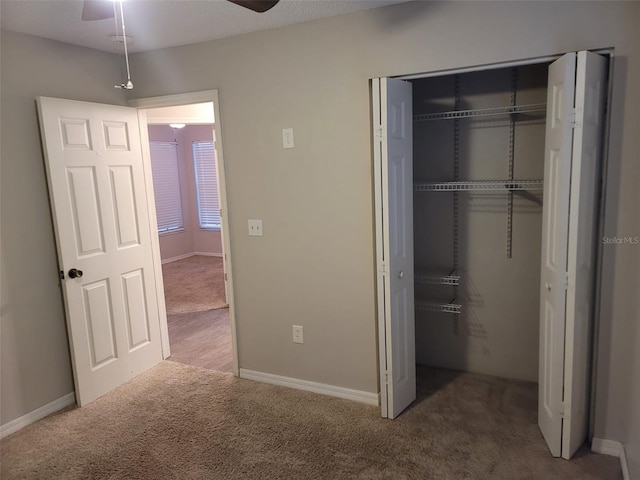 unfurnished bedroom with carpet and a closet