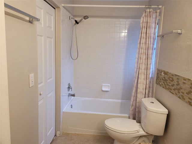 bathroom featuring toilet and shower / bath combination with curtain