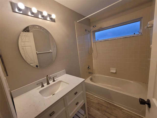 bathroom featuring vanity and tiled shower / bath