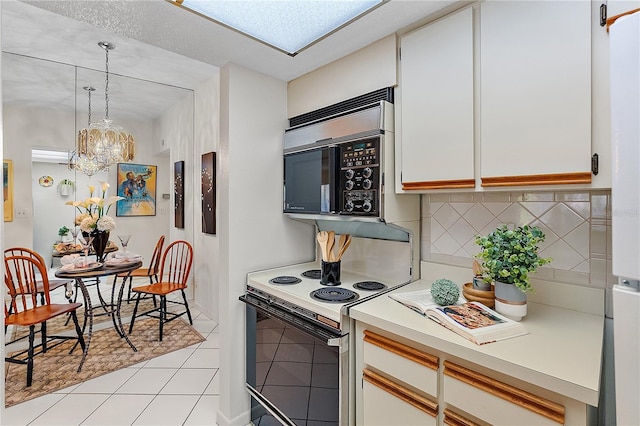 kitchen with white cabinetry, electric range, hanging light fixtures, a notable chandelier, and backsplash