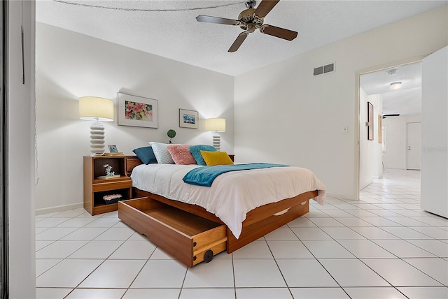 tiled bedroom with a textured ceiling and ceiling fan