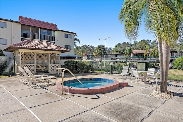 view of pool featuring a community hot tub and a patio