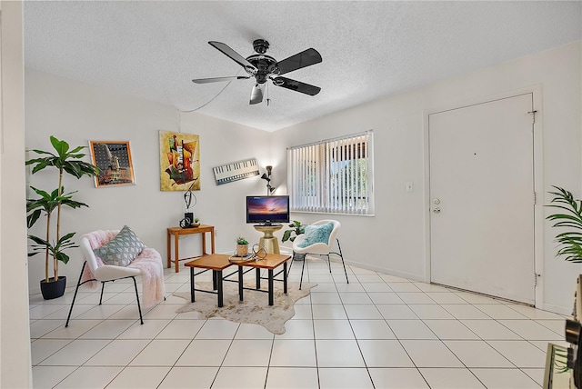 living area with lofted ceiling, light tile patterned floors, a textured ceiling, and ceiling fan