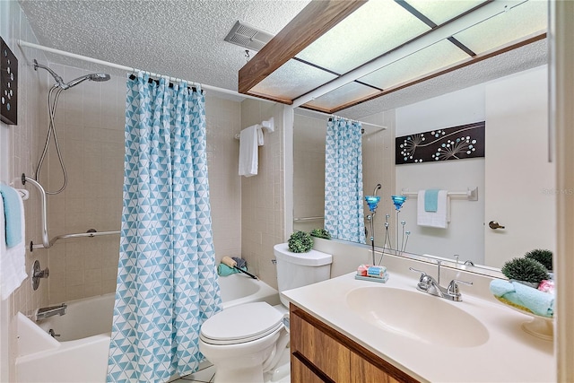 full bathroom featuring vanity, shower / tub combo with curtain, a textured ceiling, and toilet