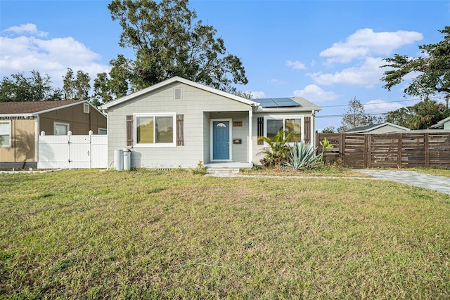 view of front of home featuring a front yard and solar panels