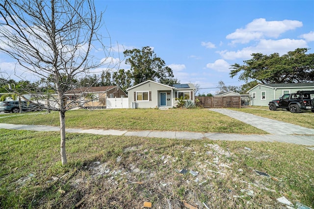 view of front of house featuring a front yard and solar panels