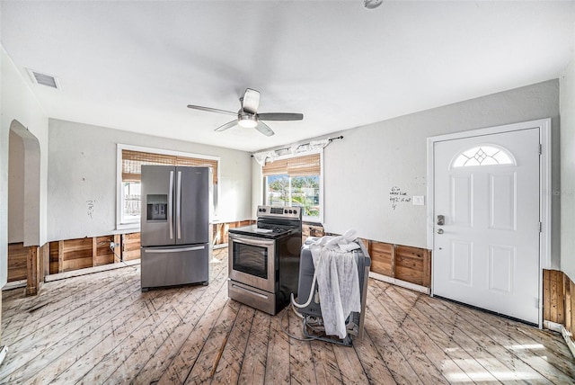 kitchen with appliances with stainless steel finishes, hardwood / wood-style flooring, and ceiling fan