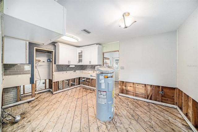 kitchen featuring light wood-type flooring and white cabinetry