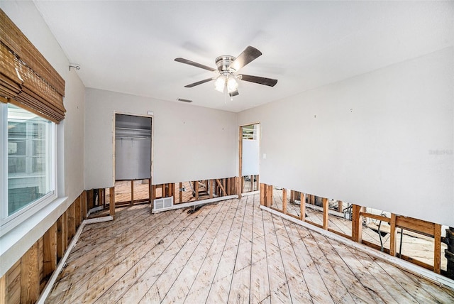 spare room with light wood-type flooring and ceiling fan