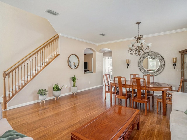 dining room with a chandelier, hardwood / wood-style floors, and ornamental molding