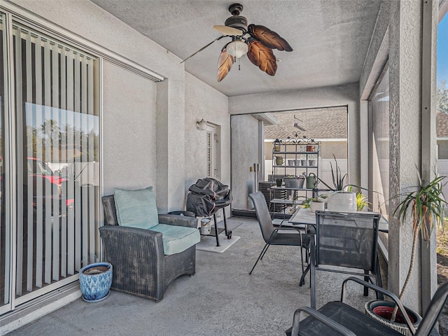 sunroom featuring ceiling fan