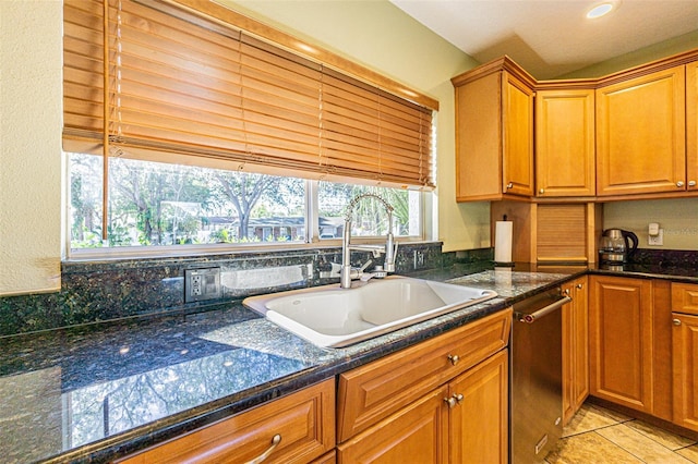 kitchen with light tile patterned floors, a wealth of natural light, dishwasher, and sink