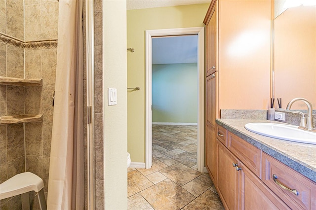 bathroom featuring toilet, vanity, and a shower with shower curtain