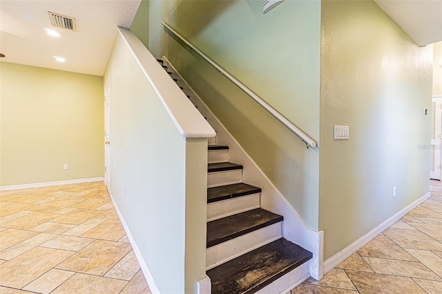 stairs with tile patterned flooring