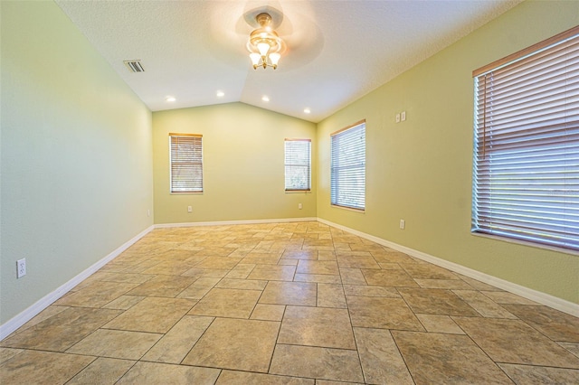 spare room with ceiling fan, a textured ceiling, and vaulted ceiling