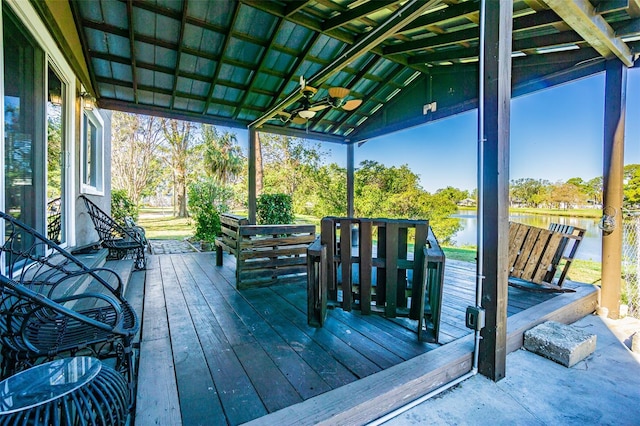 deck featuring ceiling fan and a water view