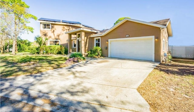 view of front of home with a garage and solar panels