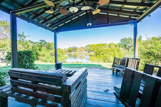 wooden deck featuring a water view and ceiling fan