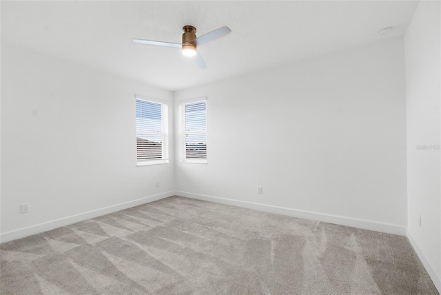 unfurnished room with ceiling fan and light carpet