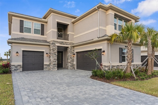 view of front of house featuring a balcony and a garage