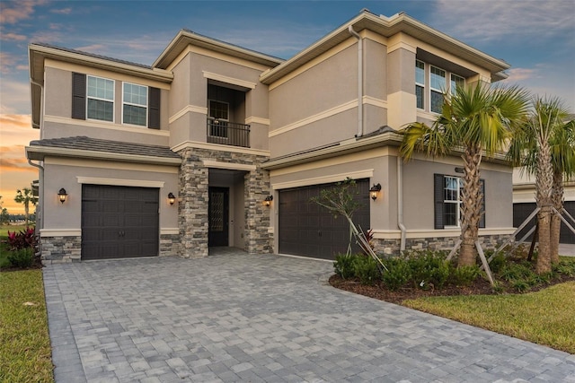 view of front of house featuring a balcony and a garage