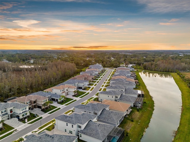 aerial view at dusk with a water view