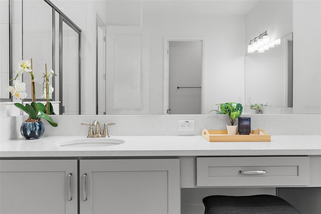 bathroom with vanity and a shower with shower door