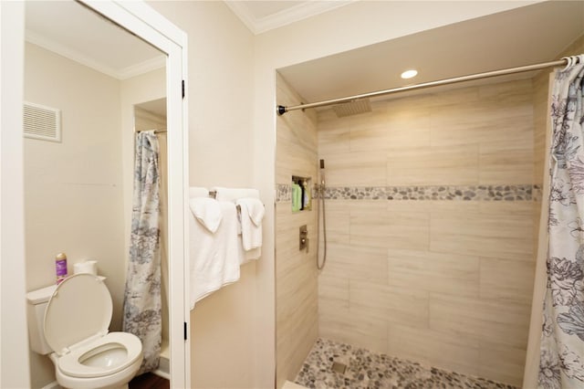 bathroom with ornamental molding, toilet, and walk in shower