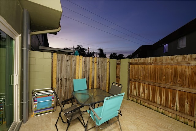 view of patio terrace at dusk