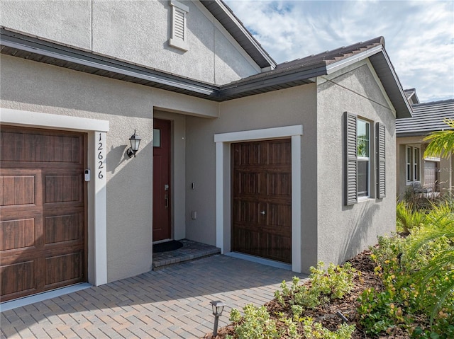 view of exterior entry featuring a garage