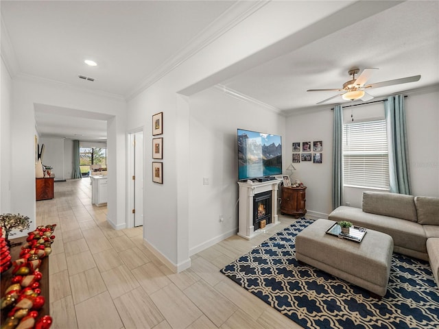 living room with ceiling fan and ornamental molding