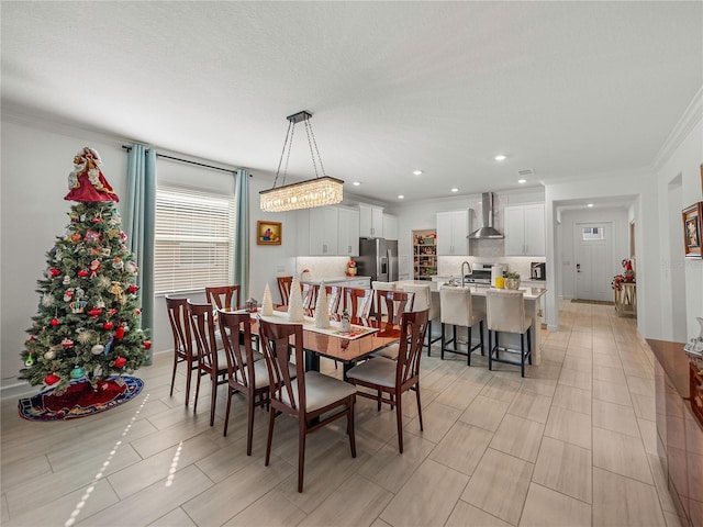 dining space featuring crown molding and sink