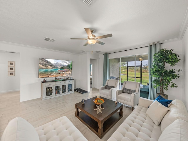 living room with ceiling fan and ornamental molding