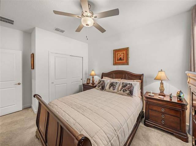 carpeted bedroom with ceiling fan and a closet