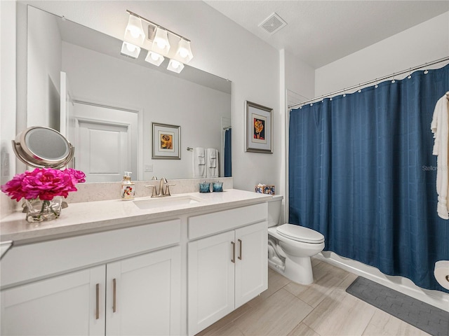 full bathroom with shower / bath combo with shower curtain, vanity, and toilet