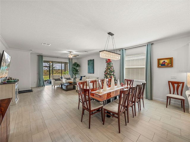 dining space featuring a textured ceiling, ceiling fan, and ornamental molding