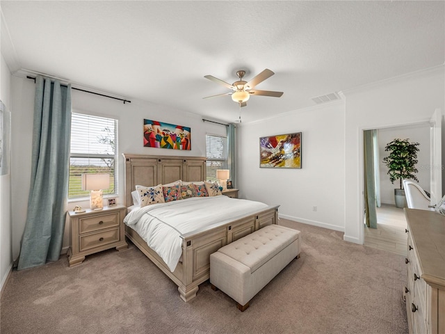 carpeted bedroom featuring ceiling fan and crown molding