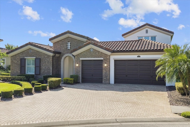 mediterranean / spanish home with a garage