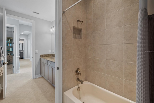 bathroom with tile patterned floors, vanity, and shower / bathtub combination with curtain