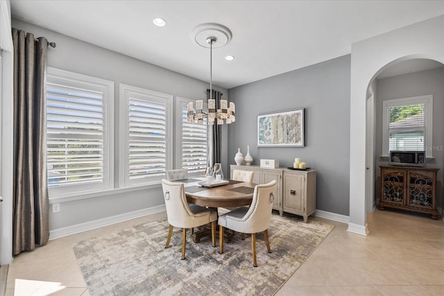 tiled dining area with an inviting chandelier