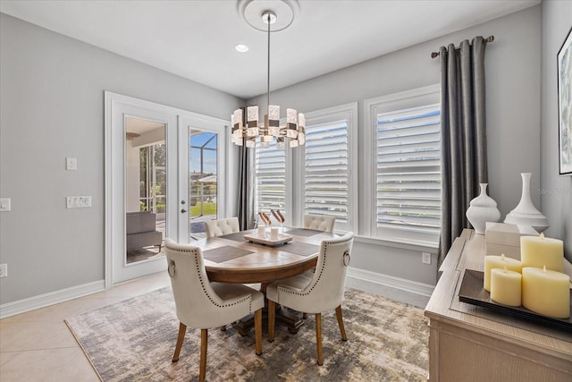 tiled dining area with french doors and a notable chandelier