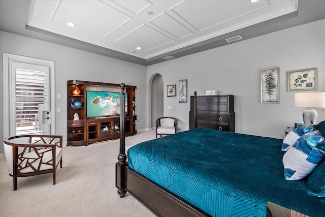 carpeted bedroom with a raised ceiling, coffered ceiling, and ornamental molding