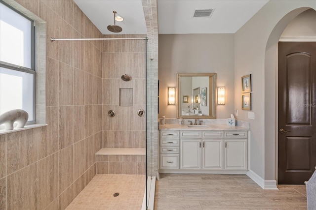 bathroom with vanity and tiled shower