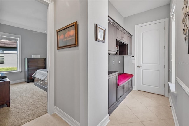 hallway featuring light colored carpet