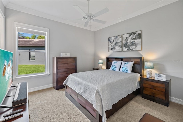 carpeted bedroom featuring ceiling fan, ornamental molding, and multiple windows